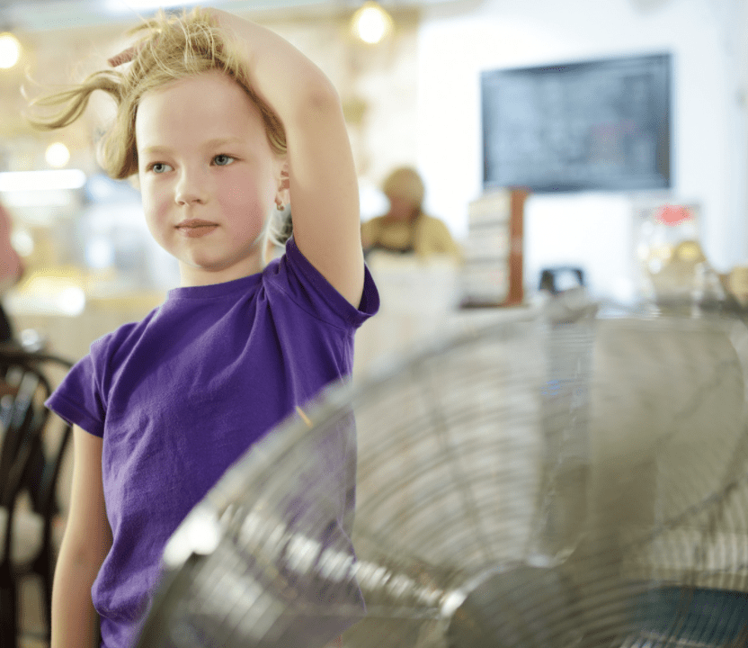 girl in front of fan